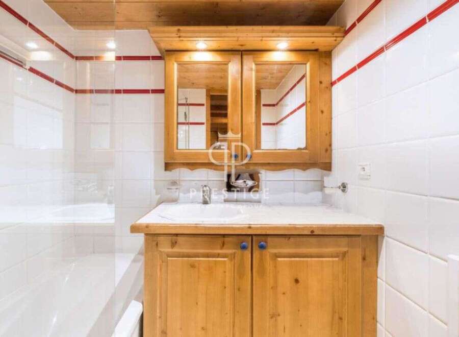 This charming bathroom features a rustic wooden vanity with ample storage.