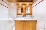 This charming bathroom features a rustic wooden vanity with ample storage.