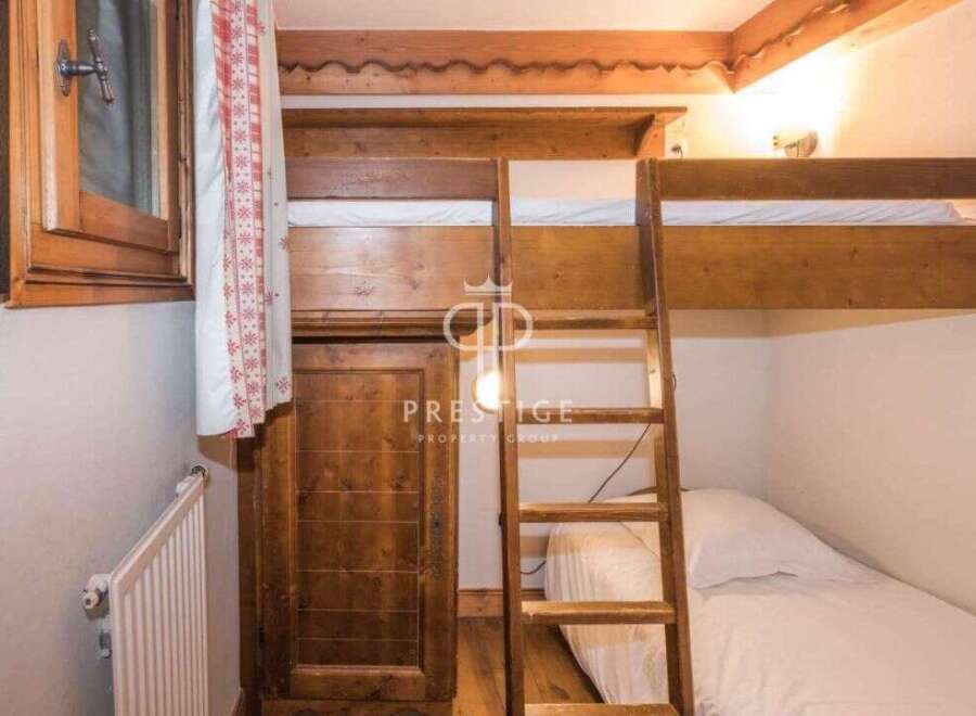 Discover the charm of this cozy bedroom featuring a unique bunk bed design.