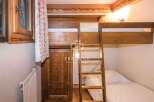 Discover the charm of this cozy bedroom featuring a unique bunk bed design.