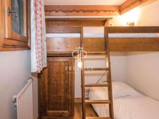 Discover the charm of this cozy bedroom featuring a unique bunk bed design.