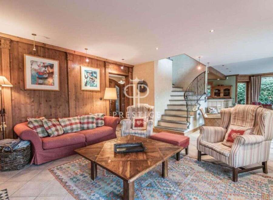 Discover the charm of this stunning property, featuring a cozy living room with a comfortable sofa and inviting armchairs.