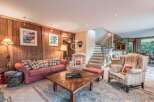 Discover the charm of this stunning property, featuring a cozy living room with a comfortable sofa and inviting armchairs.