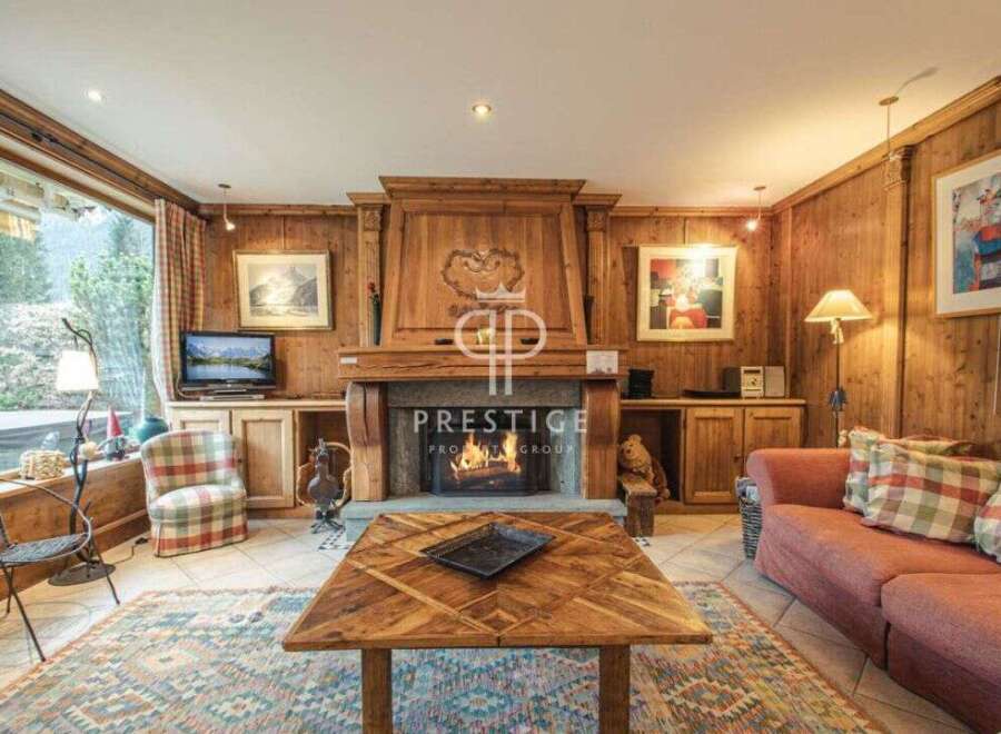 Experience the warmth of this charming property, featuring a cozy fireplace and inviting wooden accents throughout.