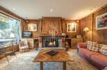 Experience the warmth of this charming property, featuring a cozy fireplace and inviting wooden accents throughout.