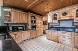 Step into a beautifully designed kitchen featuring custom cabinetry and sleek black countertops.