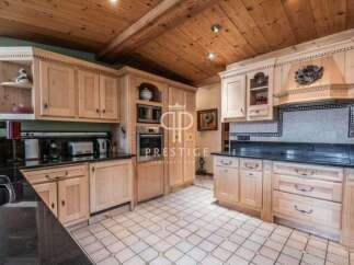 Step into a beautifully designed kitchen featuring custom cabinetry and sleek black countertops.
