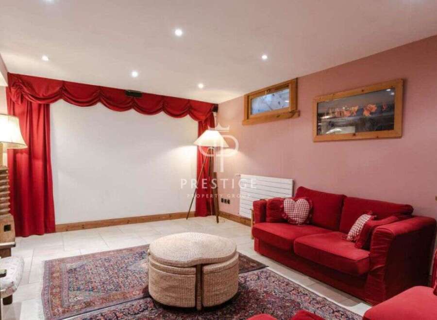 Step into luxury with this stunning property! Featuring a cozy living room with a vibrant red sofa and elegant curtains, perfect for relaxation.