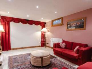 Step into luxury with this stunning property! Featuring a cozy living room with a vibrant red sofa and elegant curtains, perfect for relaxation.