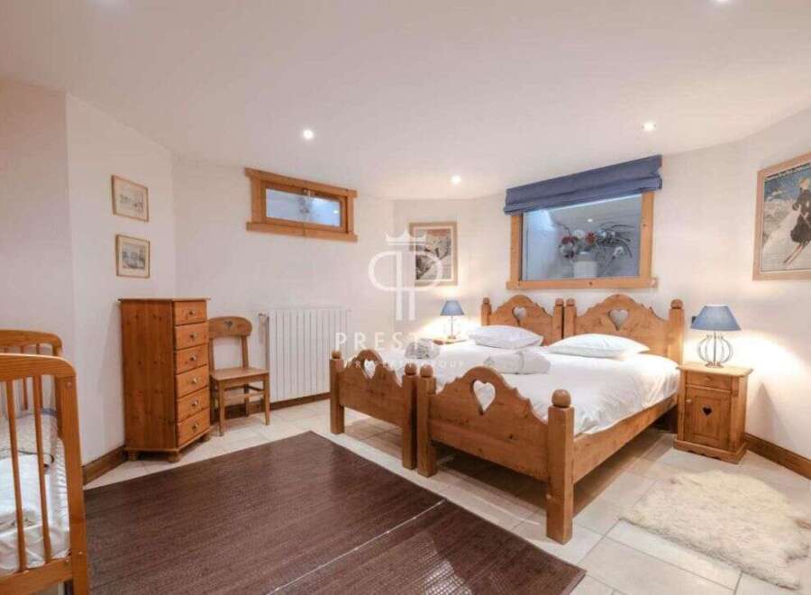 Discover a cozy bedroom retreat with charming wooden furniture and a touch of rustic elegance.
