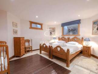 Discover a cozy bedroom retreat with charming wooden furniture and a touch of rustic elegance.