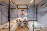 Discover a cozy bedroom with twin beds, perfect for a relaxing stay.