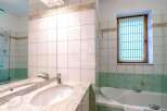 This bathroom features a stylish design with a modern sink and a luxurious bathtub.