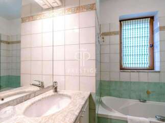 This bathroom features a stylish design with a modern sink and a luxurious bathtub.