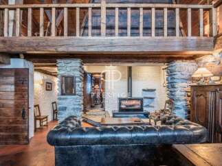 Discover the charm of this rustic property, featuring a cozy fireplace and exposed wooden beams.