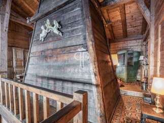 Discover the rustic charm of this unique property, featuring stunning wooden architecture and a cozy ambiance.