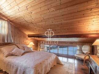 Discover the charm of this cozy bedroom with its wooden ceiling and walls, creating a warm and inviting atmosphere.