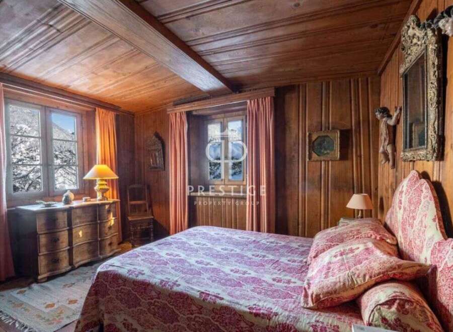 Step into a cozy bedroom retreat, adorned with rich wooden paneling and a charming, rustic ambiance.