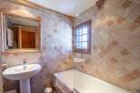 Discover the charm of this bathroom, featuring a unique tiled design that adds character.
