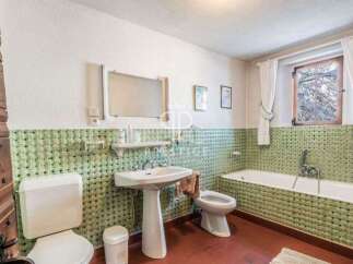 Step into this charming bathroom, featuring a classic design with a touch of vintage flair.
