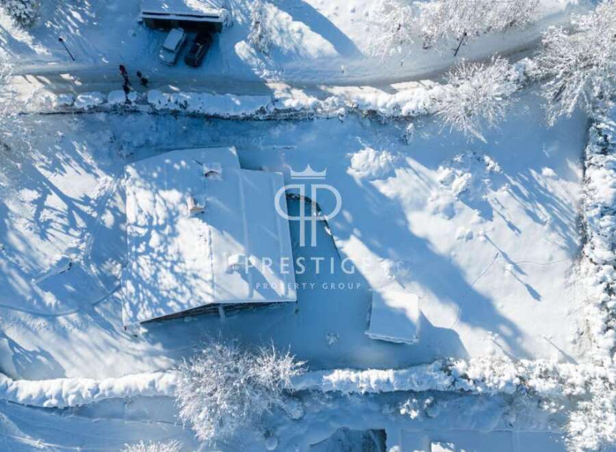 Discover a winter wonderland with this stunning property! Nestled in a snowy landscape, this home offers a serene escape.
