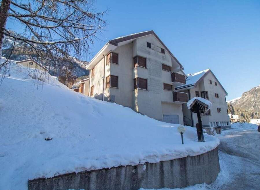 Discover a charming property nestled in a snowy landscape, perfect for a winter getaway.