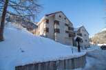 Discover a charming property nestled in a snowy landscape, perfect for a winter getaway.