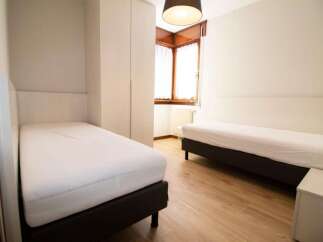 Discover a cozy bedroom featuring two comfortable beds, perfect for a relaxing stay.