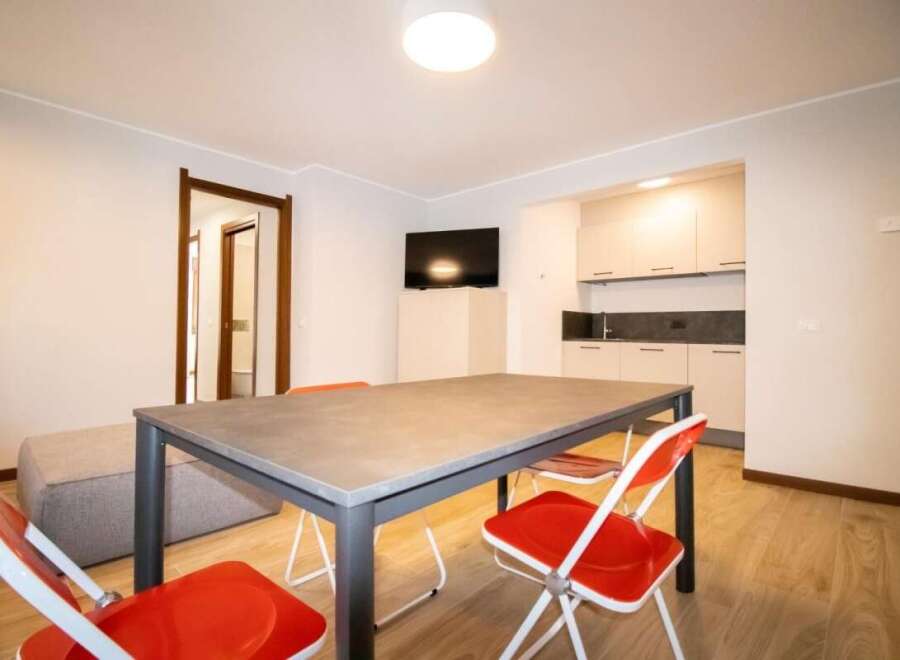 Discover a modern living space with a sleek dining area, perfect for meals and gatherings.