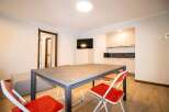 Discover a modern living space with a sleek dining area, perfect for meals and gatherings.