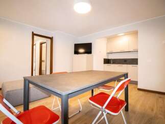 Discover a modern living space with a sleek dining area, perfect for meals and gatherings.