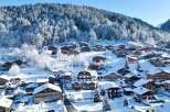 Discover the charm of a snow-covered village nestled in the mountains.