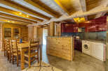 Experience rustic charm in this mountain chalet featuring a spacious wooden dining area perfect for family gatherings.