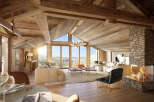 Experience luxury living in this stunning chalet, featuring a cozy fireplace and expansive windows that frame breathtaking mountain views.