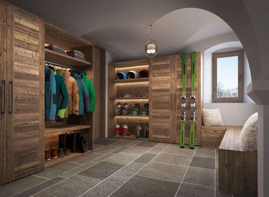 This ski storage room is the perfect blend of rustic charm and modern functionality.