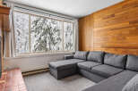 Cozy living space with a stunning view! This property features a comfortable gray sectional sofa, perfect for relaxing.