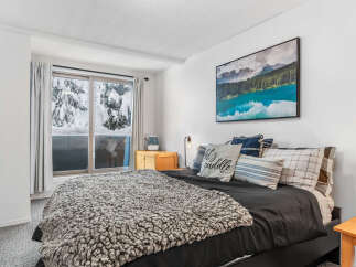 Cozy bedroom with a stunning mountain view.