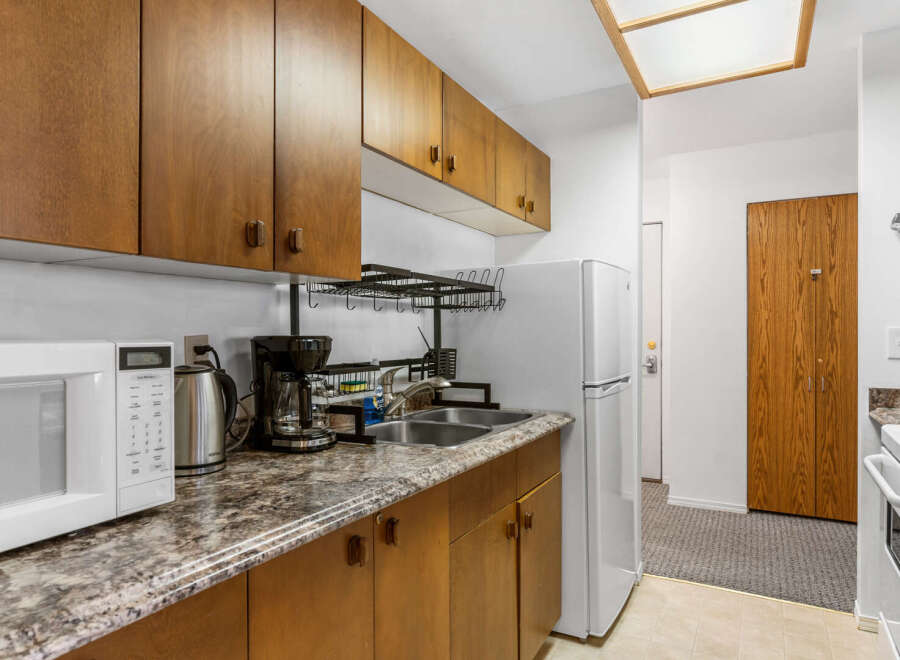 Discover this charming kitchen with ample cabinet space and a modern microwave.