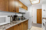 Discover this charming kitchen with ample cabinet space and a modern microwave.