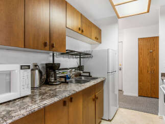 Discover this charming kitchen with ample cabinet space and a modern microwave.