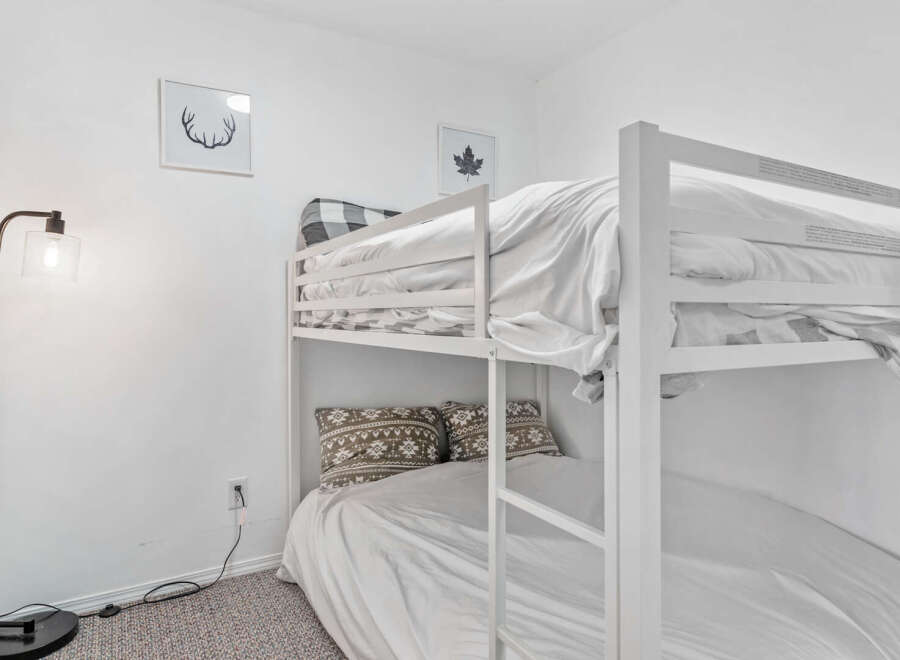 Cozy bunk beds offer a comfortable sleeping arrangement, perfect for families or groups.