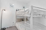 Cozy bunk beds offer a comfortable sleeping arrangement, perfect for families or groups.