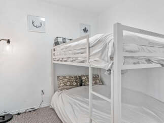 Cozy bunk beds offer a comfortable sleeping arrangement, perfect for families or groups.
