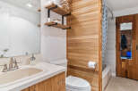 Discover a stylish bathroom with a unique wooden accent wall.