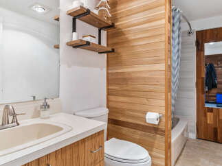 Discover a stylish bathroom with a unique wooden accent wall.