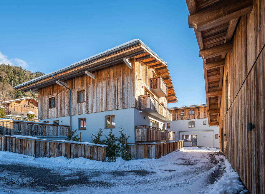 Discover the charm of this stunning wooden chalet, nestled in a picturesque winter landscape.