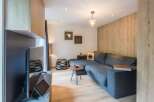 This stylish living space features a modern gray sectional sofa, perfect for relaxing.