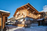 Discover the charm of this stunning wooden chalet nestled in a picturesque winter landscape.
