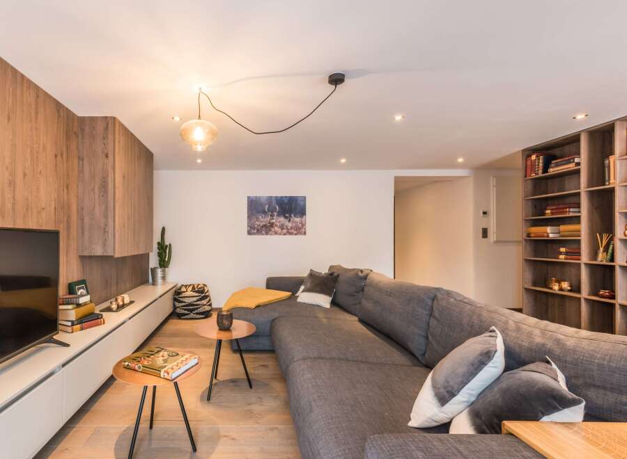 This modern living room features a stylish gray sectional sofa, perfect for relaxing.