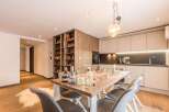 This stunning property boasts a modern kitchen with sleek cabinetry and top-of-the-line appliances.